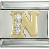 Letra N en oro con piedras, sobre plata